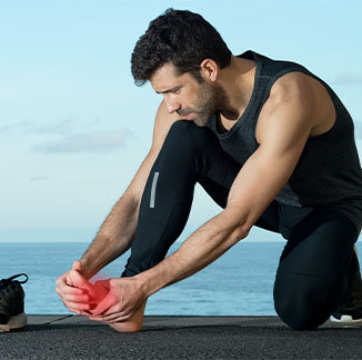 man holding his feet